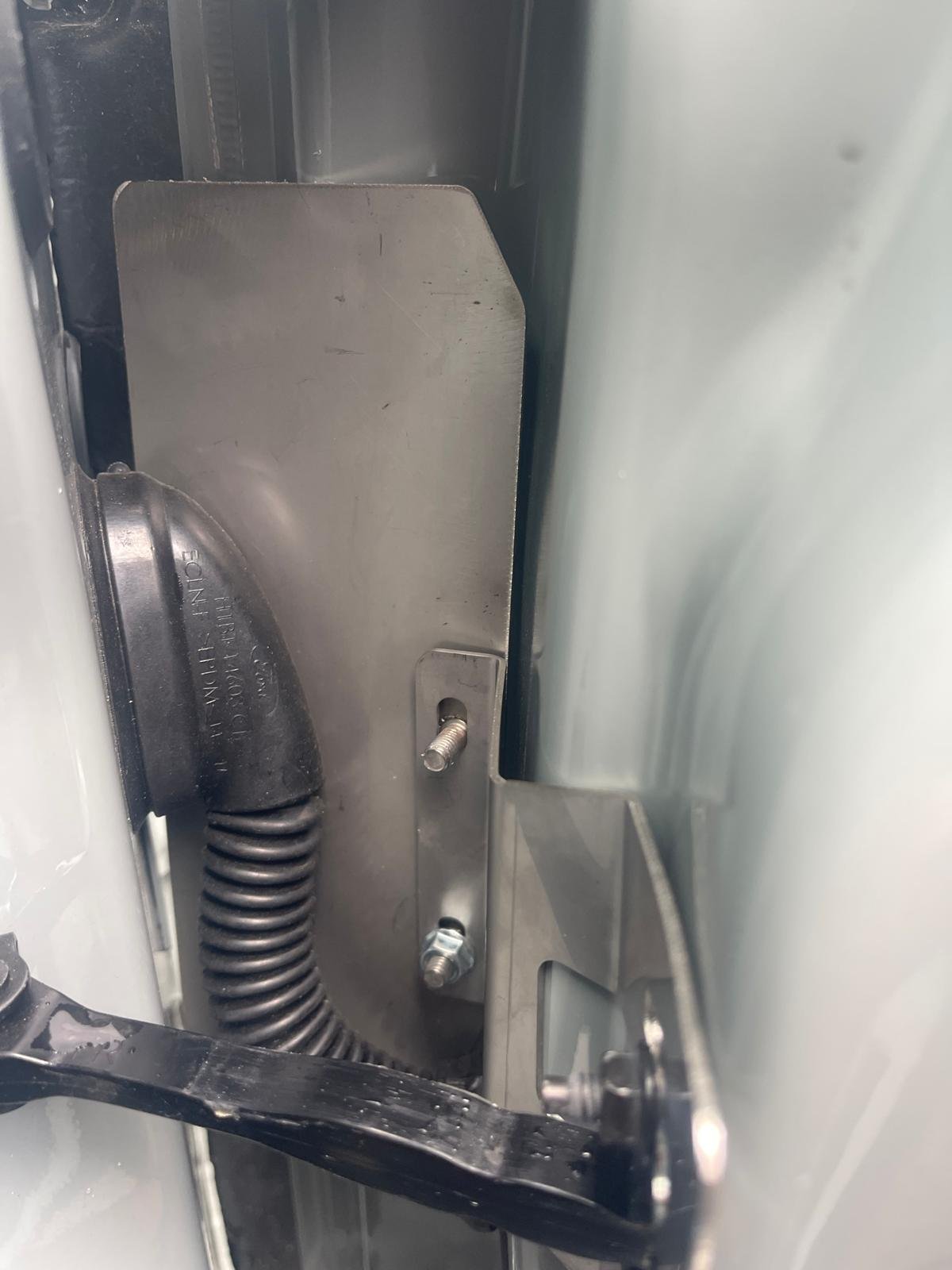 Internal armoured shielding bracket fitted inside a van door